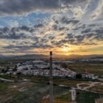 Aerial view of Malaga during golden hour with warm Mediterranean light